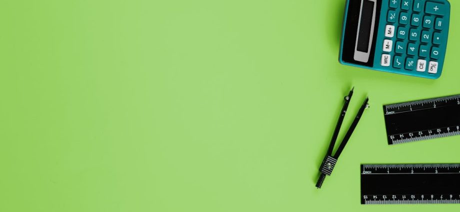Calculator and drawing tools on a vibrant green background with ample copy space.